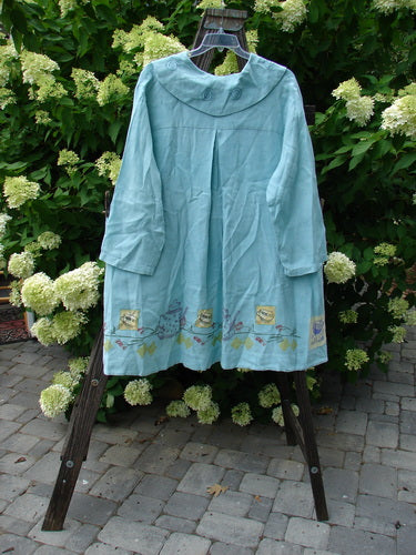 Image alt text: "1999 Breeze Jacket Cherry Tea Time Spring OSFA: Blue dress on a rack, blue shirt on a clothes rack, blue robe on a rack, tablecloth under a tablecloth"