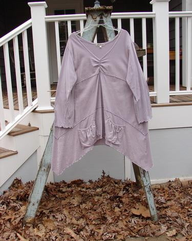 Barclay Cotton Lycra Vertical Gather Drop Pocket Dress Unpainted Lavender Size 2: A dress with a deeper V-shaped neckline, widening shape, and varying hemline. Features two oversized front gathered pockets, sweet lettuce edges, and sectional horizontal panels.
