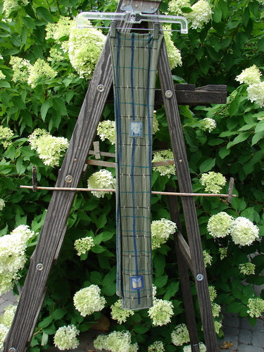 Image alt text: "Barclay Patched Scarf on wooden easel in outdoor garden"