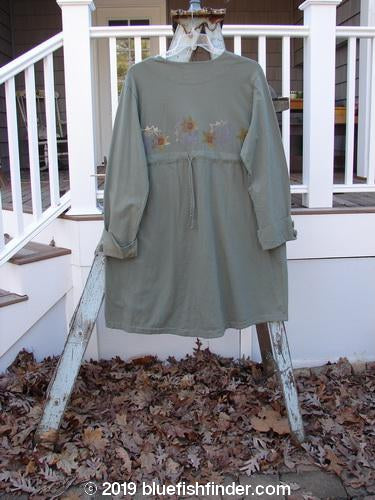 2000 Puzzle Jacket Star Eucalyptus Size 1: Long-sleeved dress on a swinger with cuffed and tabbed lower button sleeves, deep V-shaped neckline, and front accent pockets. Drawstring back and varying hemline.