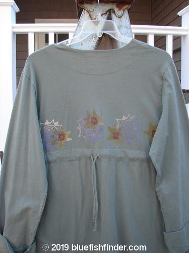 2000 Puzzle Jacket Star Eucalyptus Size 1: A long-sleeved shirt with a star design, cuffed sleeves, a deep V neckline, and front accent pockets.