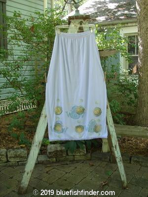 A white skirt with lace trim and a frog and rose theme painted on it, made from organic cotton. Perfect condition. Size 0.