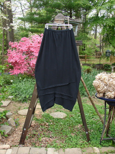2000 Thermal Awen Skirt, black cotton with lycra, full elastic waist, bell-shaped lower taper, textured diagonal hemline. Size 2.
