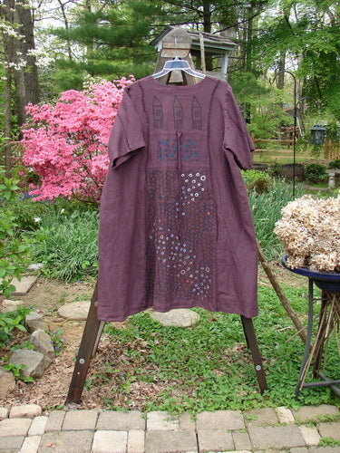 Barclay Linen Double Tie Back Jacket Honeycomb Maroon Size 2: A purple dress with a deep V neckline, A-line sweep, and front drop flop pockets.