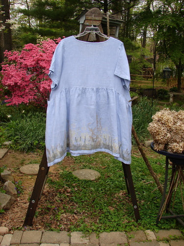 A Barclay Linen Studio Pullover Dress with a forest-themed border and a sky blue color. Size 2.