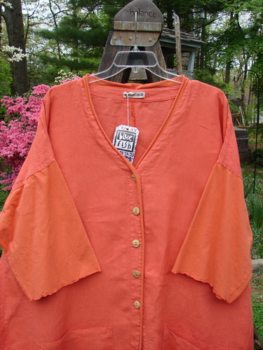 Barclay NWT Linen Cotton Sleeve Pocket Cardigan Contrast Unpainted Clementine Size 2: A light orange shirt with a price tag on a swinger.
